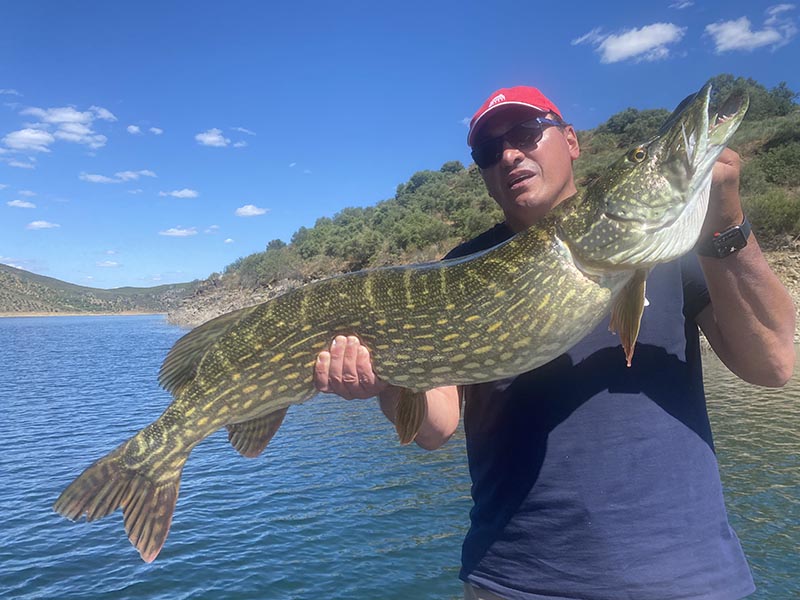 Pecheur avec un brochet sur un lac portugais